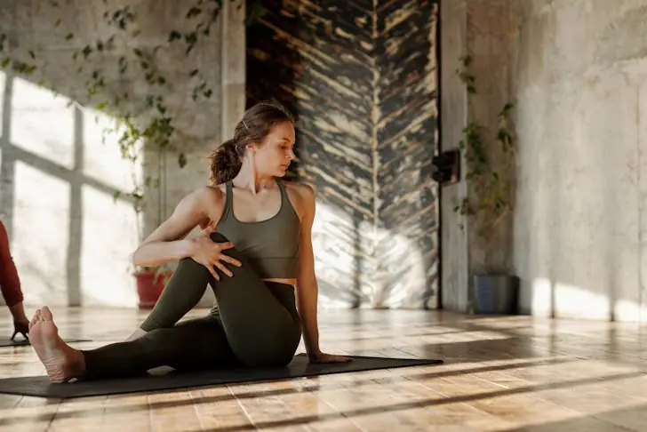 Muscle activation technique - Woman doing stretching exercise.